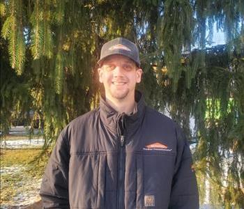 Man in front of tree