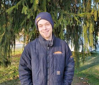 Man in front of tree